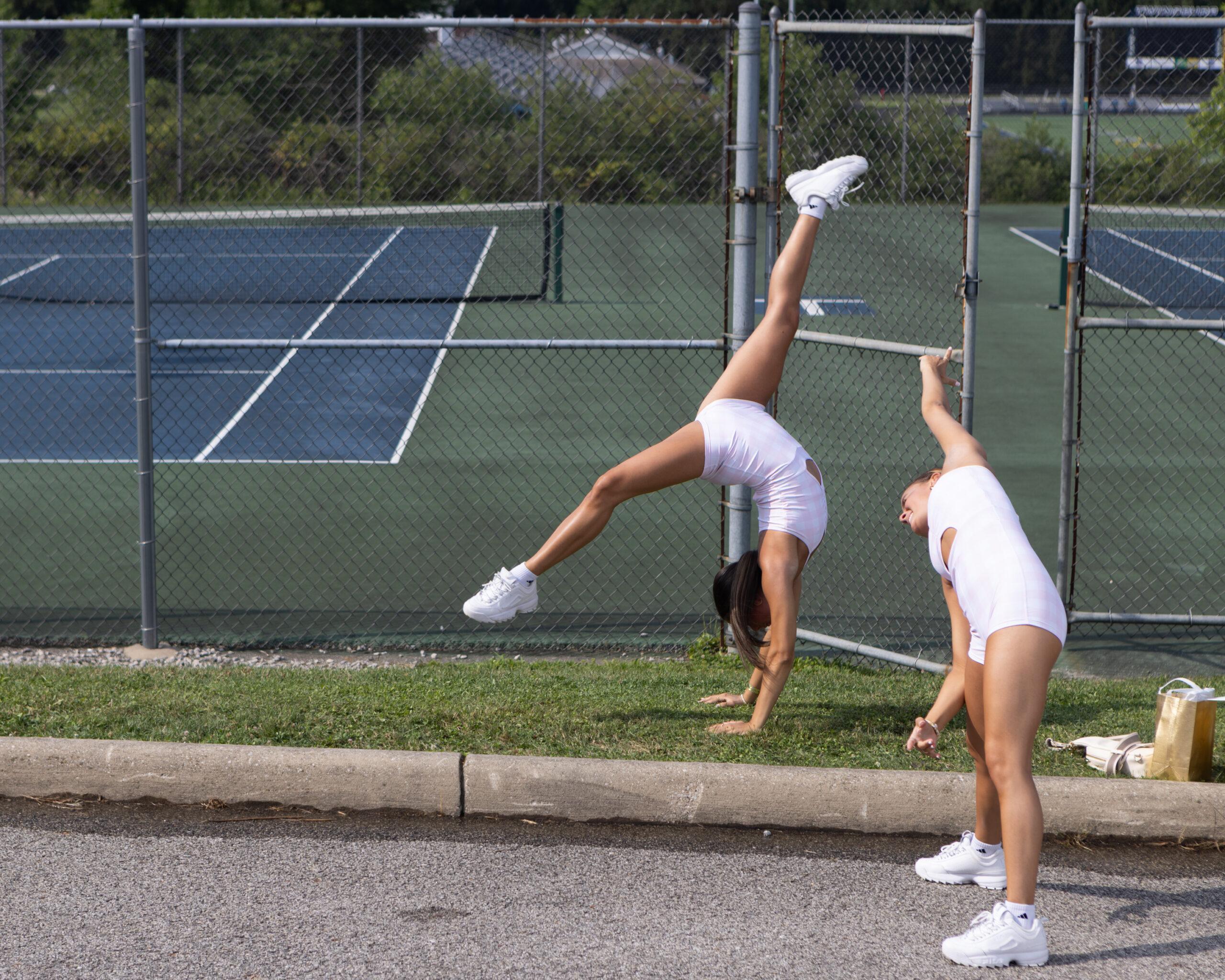 Young twin women practice gymnastics ahead of their performance at a talent show at the Twins Days festival.