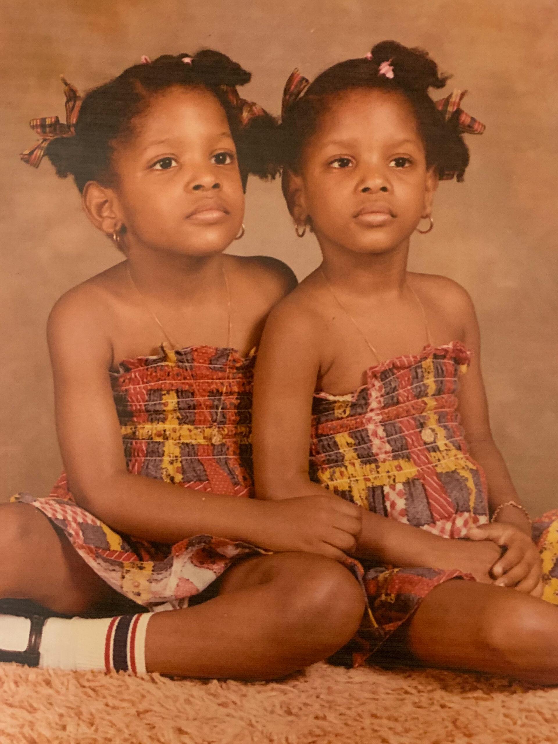 Carmelle and Cathy Jean-François are seen as young girls, posing in studio portrait.