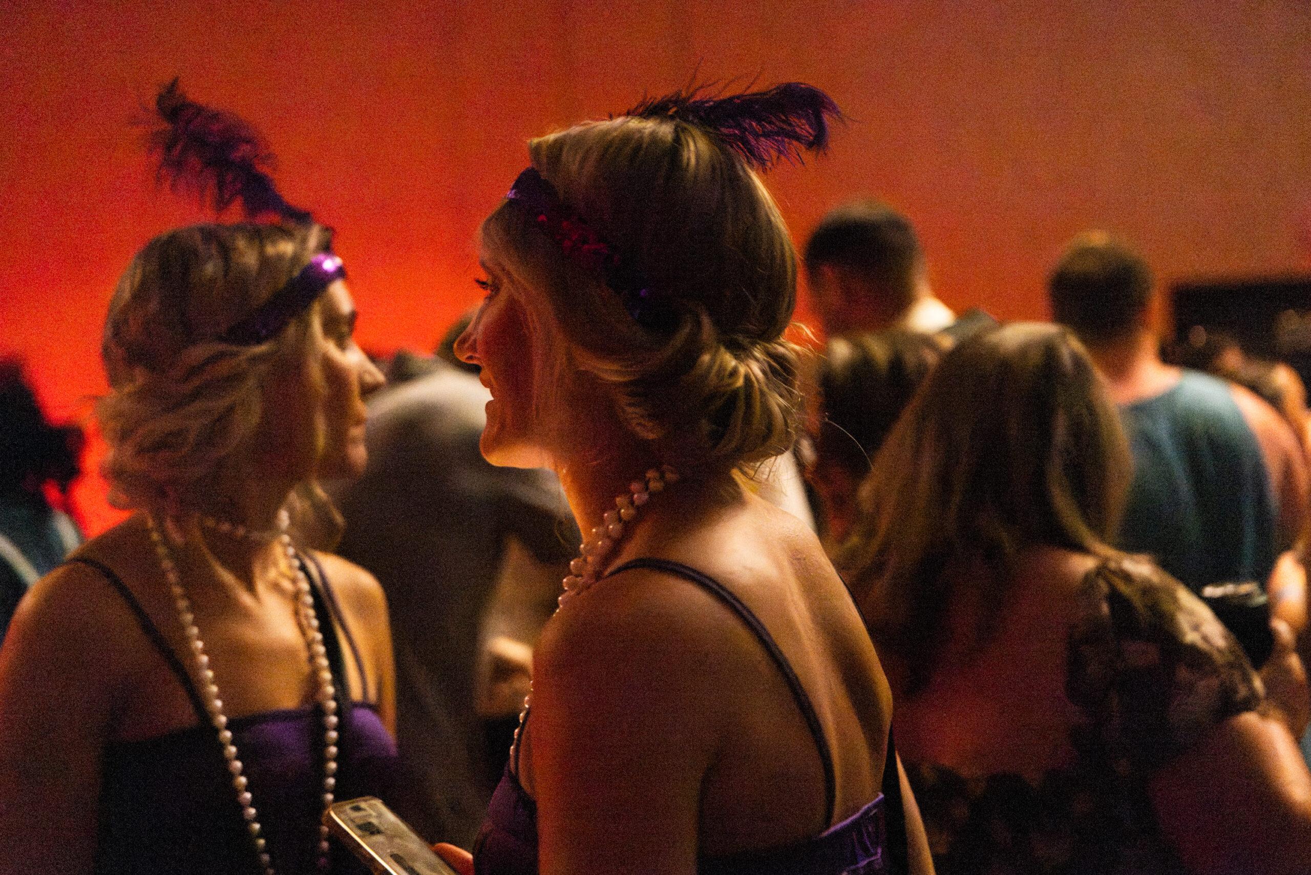Twin women dressed as 1920s flappers dance at a hotel party in Twinsburg.