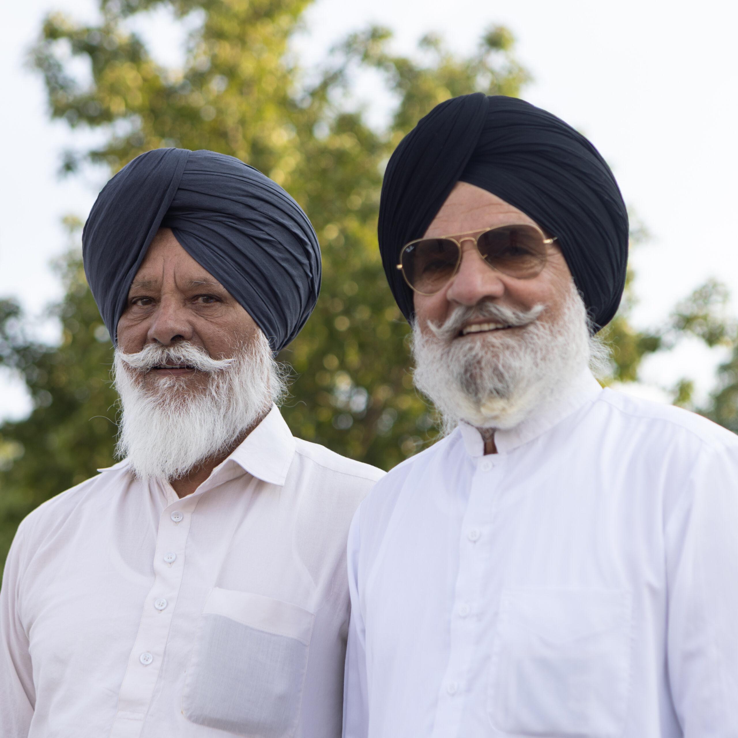 Twin men pose for a portrait at the Twins Days festival.